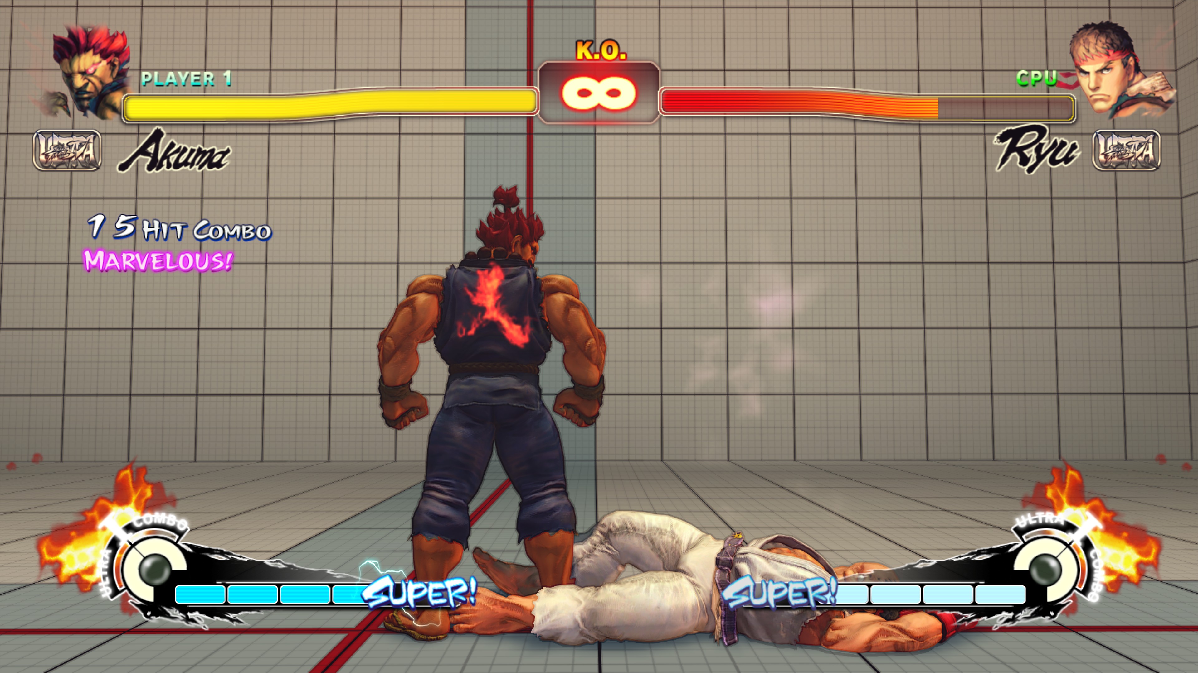 Akuma stands over a fallen Ryu in Ultra Street Fighter IV